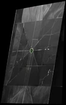 An aerial texture crossed by lines, with a small green target mark.