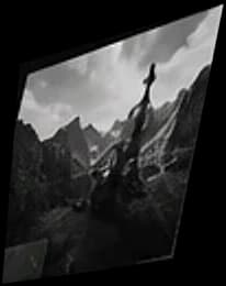 A black-and-white mountain range with a lone figure on a ridge.