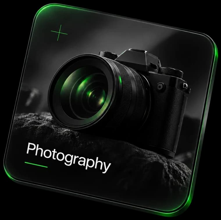 Photography: a camera on a rock, its lens lit green.
