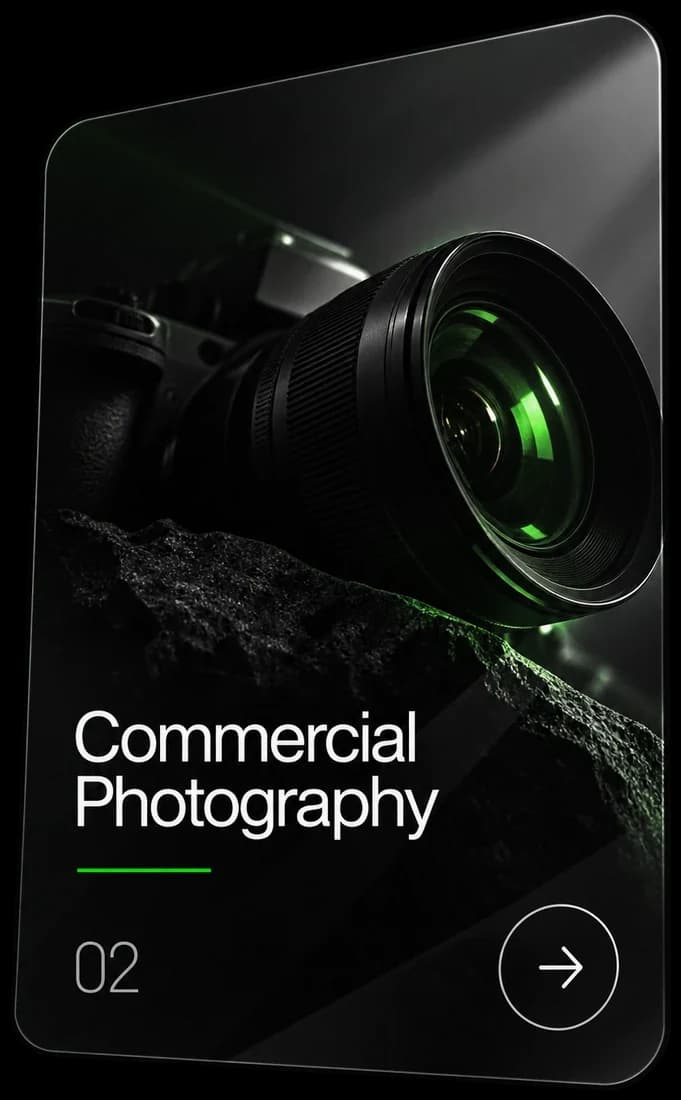 Card 02, Commercial Photography: a camera lens glowing green above dark stone.