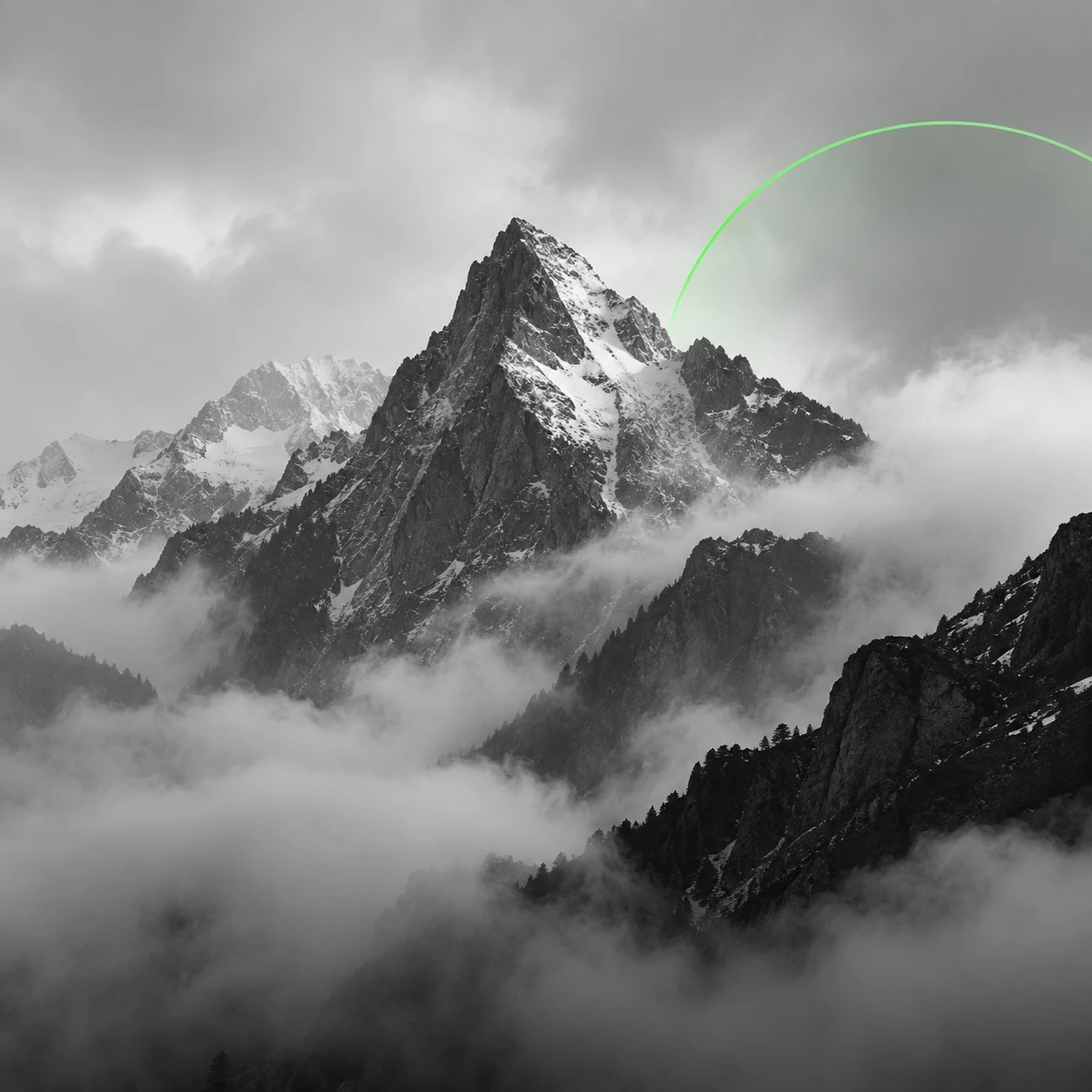 A mountain peak standing out of cloud, in black and white.
